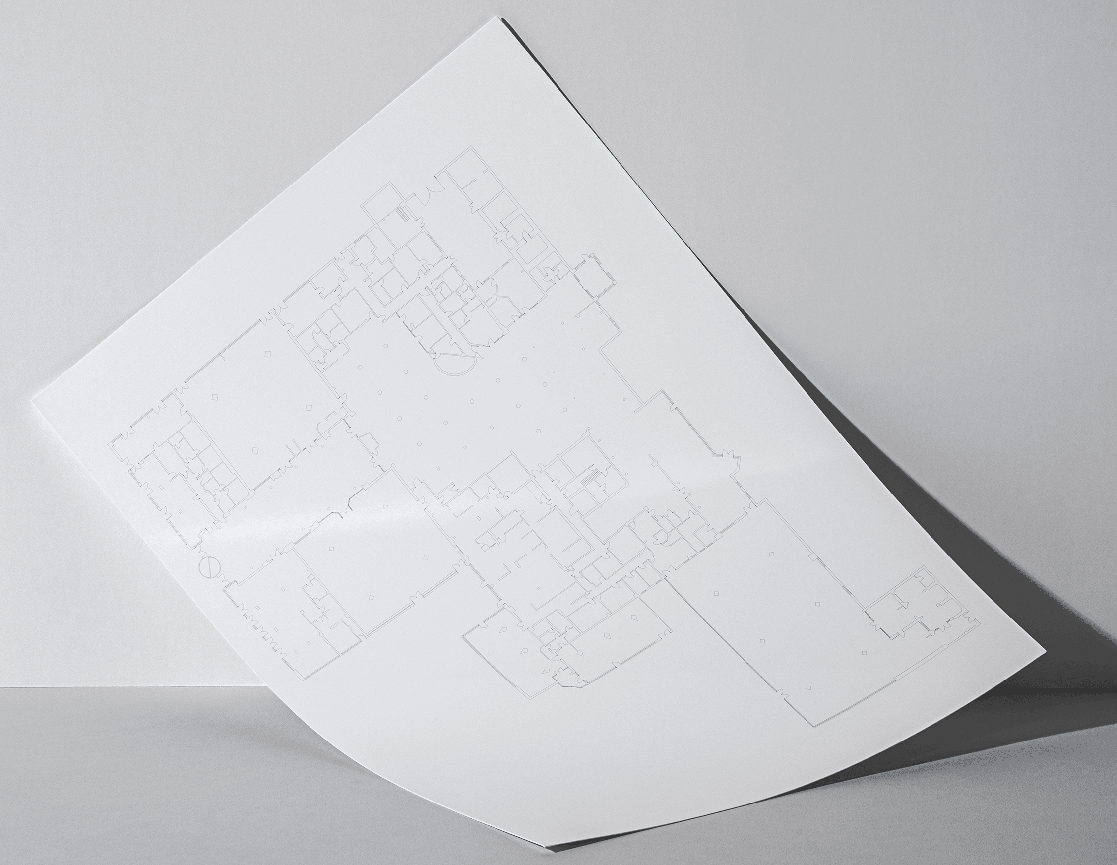 A sheet of A4 paper with the hotel's floor plan, having slid down against a wall